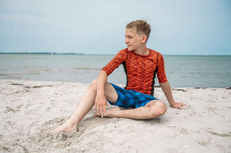 Portrait of handsom teen boy on beautiful white beach at summer holidaysの写真素材