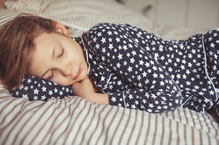 Close up portrait of pretty teen girl sleeping sweet in bedの写真素材