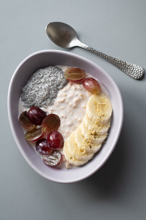 Flatlay photo of a healthy breakfast: cereal, grapes, banana, and chiaの写真素材
