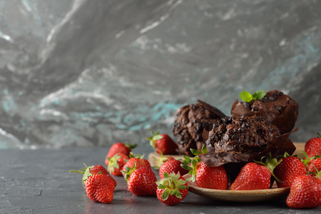 Chocolate cupcakes with strawberries on a gray backgroundの写真素材