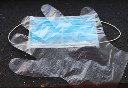Virus protection means lie on a dark background, face mask and glove