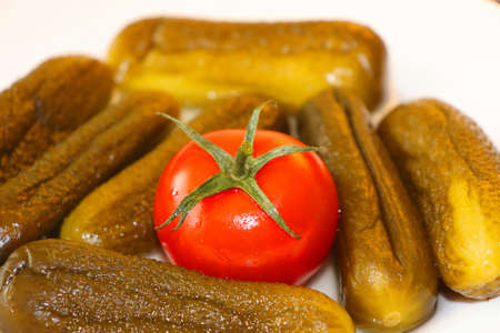 Red juicy tomatoes and pickles, foreground view, the best appetizer with vodkaの写真素材