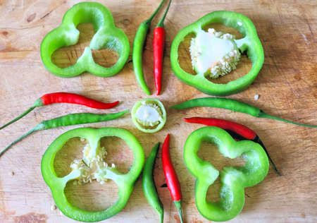 Red and green hot peppers paprika vegetables and spices on kitchen board