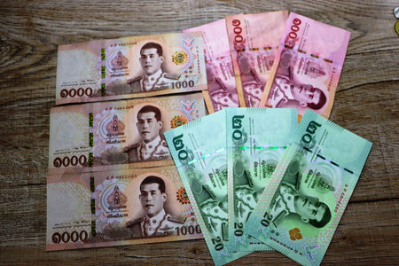 Banknotes of different countries and colors on a wooden background