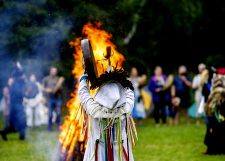 Shaman with a tambourine against the background of an evening fire, communication with spiritsの写真素材