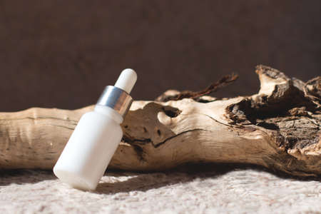 Natural cosmetics for the skin in a glass jar on a natural background.