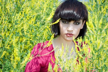 The portrait of girl in the environment of yellow flowers.の写真素材