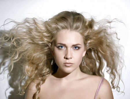 Portrait of a girl with blonde hair flying.の写真素材