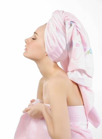 Woman in profile with his eyes closed, dressed in a pink towel.の写真素材