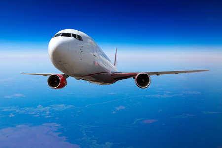 Aircraft in flight. The passenger plane flies high in the deep blue sky. front view. close up.