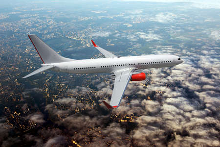 White passenger double decker plane in flight. Aircraft fly high over the clouds. View of the plane...