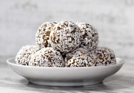 Homemade energy balls with dried apricots, raisins, dates, prunes, walnuts and coconut. Healthy...