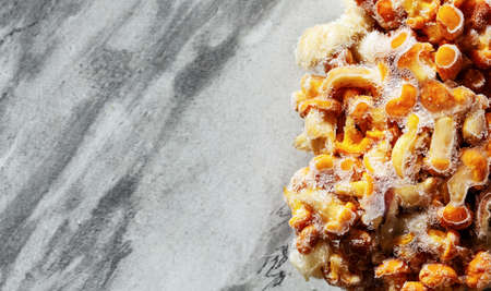 Frozen mushrooms on a gray background. Storage of frozen food. Frozen product. Chanterelles and...