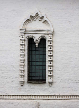 Old white stone window in the old Russian style. An old window of a 16th-century Church in Russia.の写真素材