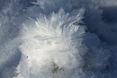 Snowy white background. The texture of the snow. Shiny snow with bokeh and blurred background...