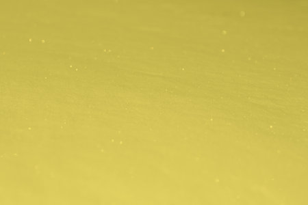 Trendy Color of the year 2021 Illuminating yellow. Snowy white background. The texture of the snow. Shiny snow with bokeh and blurred background close-up.の写真素材