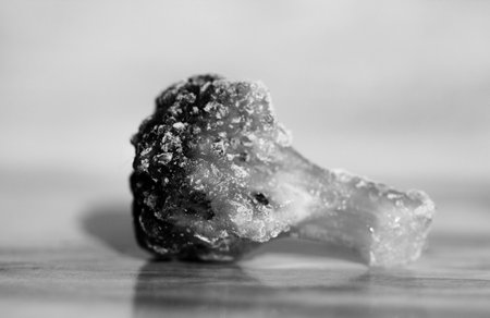 Frozen fresh broccoli on a marble table close-up. Macro. Storage of frozen food. Frozen product.の写真素材