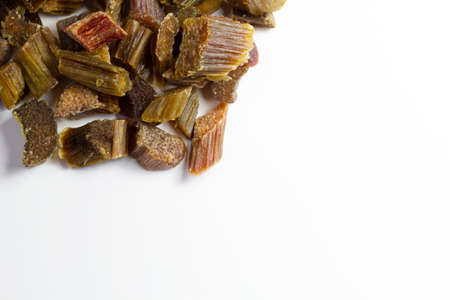 Dried rhubarb candied fruits. Candied rhubarb on a white background. Dry rhubarb close - up macro...