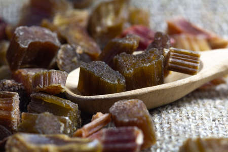 Dried rhubarb candied fruits in a wooden spoon.の写真素材