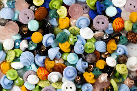 Colorful bright buttons background. Old vintage buttons close-up. Copy space. Top view. Background of buttons. Flat lay.の写真素材