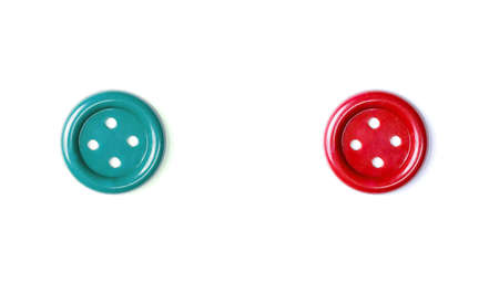 Red and green buttons on a white background close-up. Two beautiful isolate buttons for cutting out....