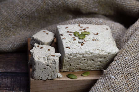 Halva close-up on a blackboard on a brown wooden background. Traditional oriental dessert sweet...
