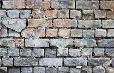 Brick background grunge texture. Stone red-gray brick wall. The wall of an old ruined brick...