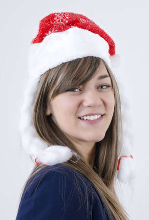 beautiful girl with pretty teeth,brown hair and New Year s cap on her head smilingの写真素材