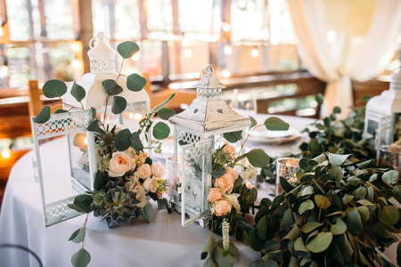 Decorated area with white wooden candle lamps and flowersの写真素材