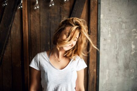 Funny girl waving her head, her hair is flyingの写真素材