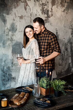 Valentine's Day. Elegant girl with a guy with glasses of wineの写真素材