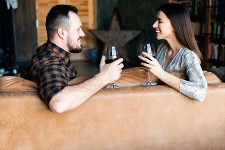 Valentine's Day. A guy and a girl talk and smile, the glasses in their handsの写真素材