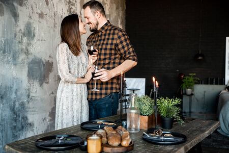 Romantic candlelight dinner. Guy with a girl with glasses of wine laughingの写真素材
