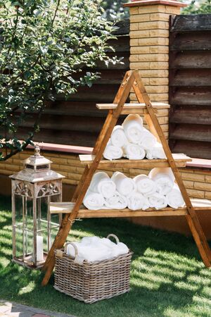Outdoor wedding ceremony in the summer. Hand towels and basket on the grassの写真素材