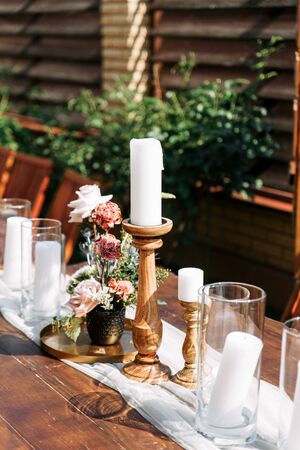Outdoor wedding ceremony at the summer. Table decor with candles and flowers.の写真素材