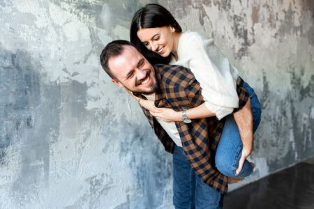 Together forever. Couple in love hug happily and smile. They are in casual clothes indoors.の写真素材
