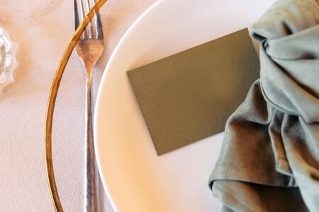 Stylish details on the festive table. Cute paper card on guest nameplate, sign for seatingの写真素材