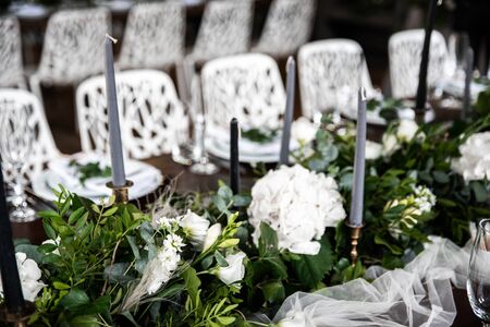 Festive table decorated with flowers and candles on a silver candlestick