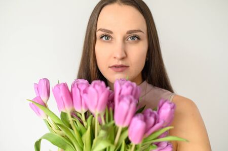 Close-up Face of a young beautiful woman in bloom. Portrait on a white backgroundの写真素材
