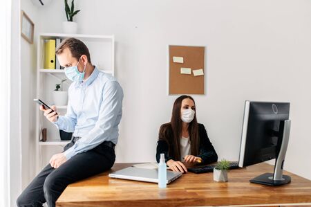 Pandemic, viral threat. Office workers in medical masks.の写真素材