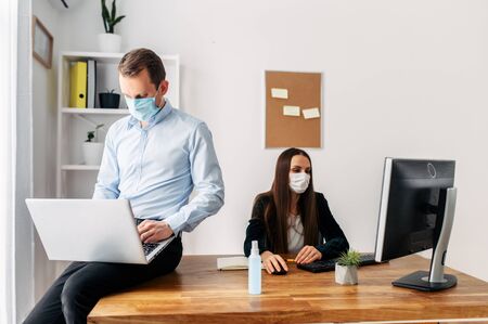 Pandemic, viral threat. Office workers in medical masks.の写真素材