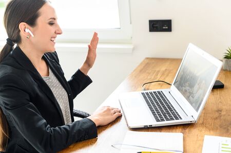 Job interview online. A young woman talks via video connection with employersの写真素材