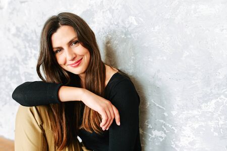 Beautiful brunette woman in suit. Studio shotの写真素材