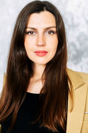 Beautiful brunette woman in suit. Studio shot