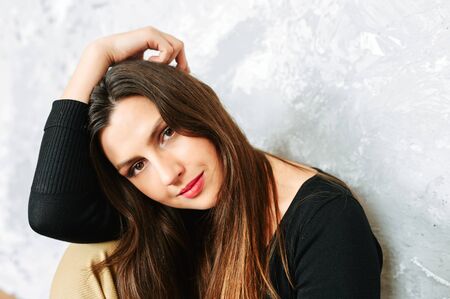 Beautiful brunette woman in suit. Studio shotの写真素材