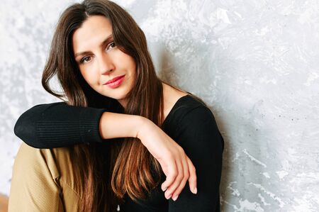 Beautiful brunette woman in suit. Studio shotの写真素材