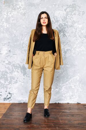 Beautiful brunette woman in suit. Studio shotの写真素材