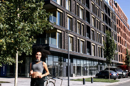 Female runner in the city. Young attractive African-American woman in sportswear running outdoors. Healthy lifestyleの写真素材