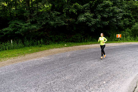 Full length shot of a slender athletic woman running outdoors. Healthy lifestyle concept