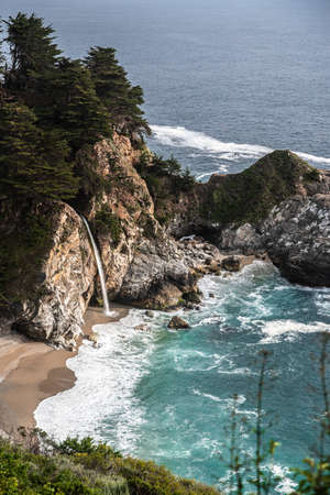 Waterfall from rocky steep coast. Breathtaking ocean and rocks view. Pacific Coast Highway, California, USAの写真素材
